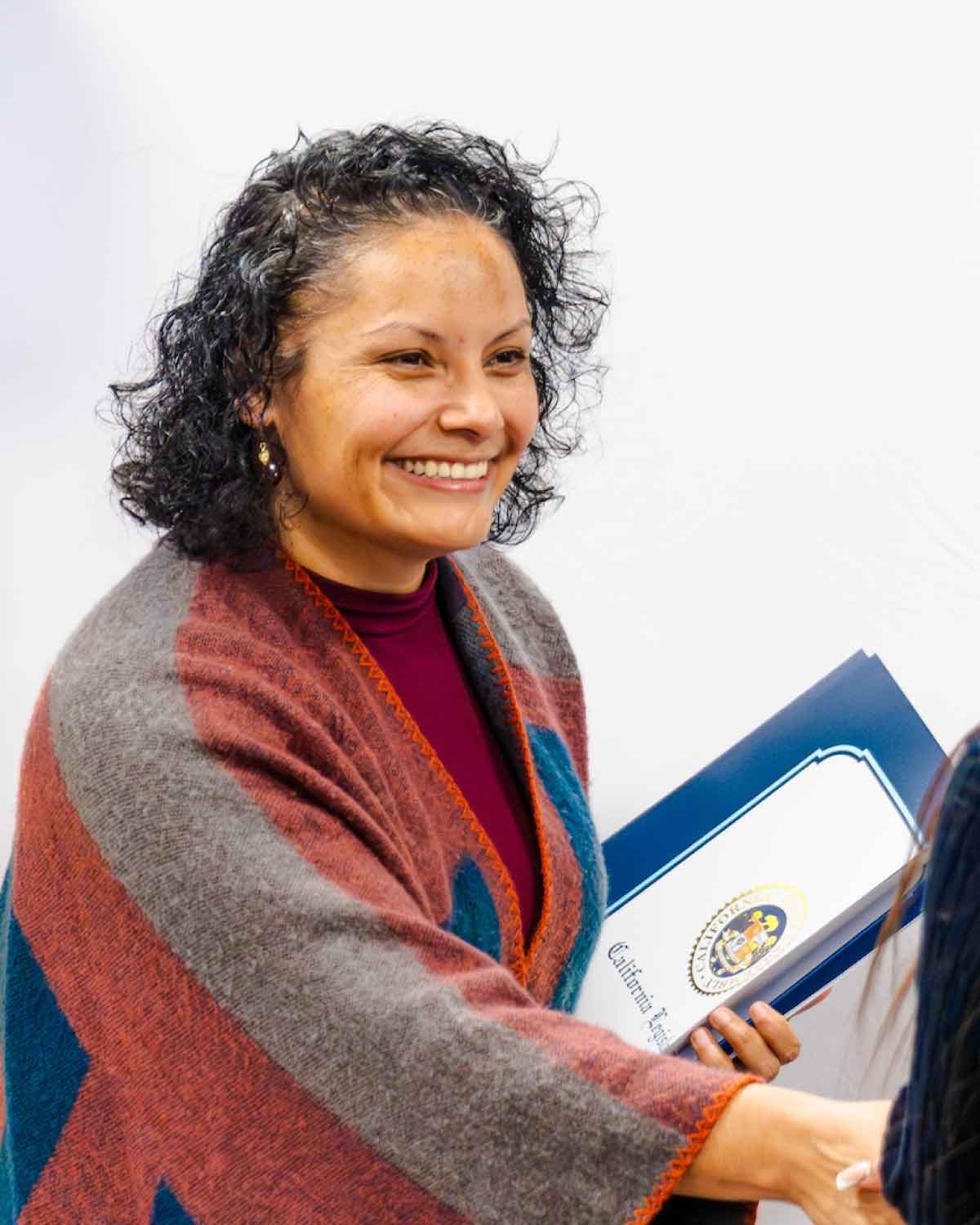 A dedicated Fresno BHC program leader warmly greeting youth interns, illustrating the supportive guidance and community-building emphasis of the Youth Internships Program, inviting more students to apply.