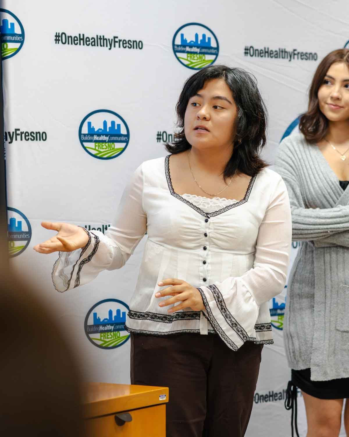 A young speaker in the Fresno BHC Youth Internships Program presenting her ideas, demonstrating community advocacy, leadership skills, and encouraging others to apply.