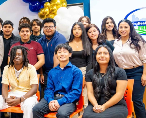 An attendee capturing the Fresno BHC Youth Internships Program event on a smartphone, reflecting the excitement and community engagement surrounding youth leadership opportunities.