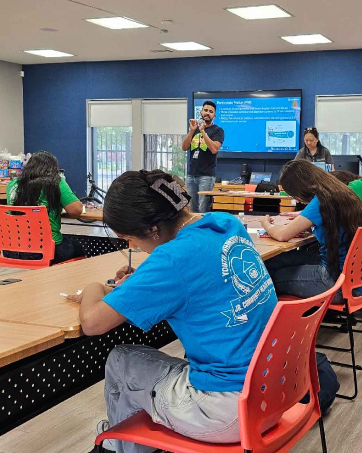 Fresno BHC Youth Interns participating in a hands-on workshop about environmental health, guided by a community mentor, emphasizing leadership development and inviting others to apply for the Youth Internships Program.