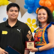 Two smiling teens wearing bright orange #Parks4All T-shirts and enjoying popsicles during a Fresno BHC community event, showcasing fun, inclusive engagement that inspires others to apply for youth leadership opportunities.