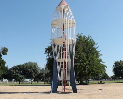 Iconic rocket-shaped play structure at Calwa Park, a beloved symbol of childhood memories and future revitalization.