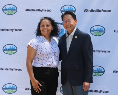 Calwa Park renovation supporters pose together in front of the Building Healthy Communities Fresno banner.