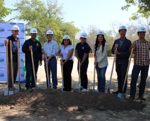 Smiling group of community leaders and officials pose together for the ceremonial shovel dig at Calwa Park’s renovation launch.