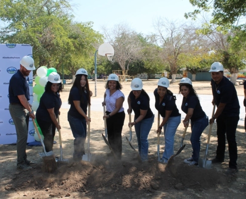 Fresno Building Healthy Communities team poses mid-shovel during Calwa Park Renovation groundbreaking ceremony.