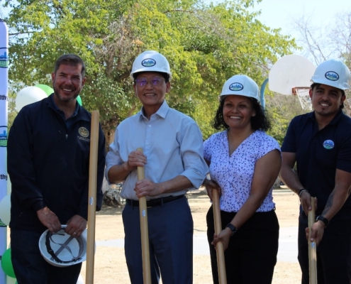 Close-up of smiling community leaders holding shovels at the Calwa Park groundbreaking, celebrating the start of the renovation.