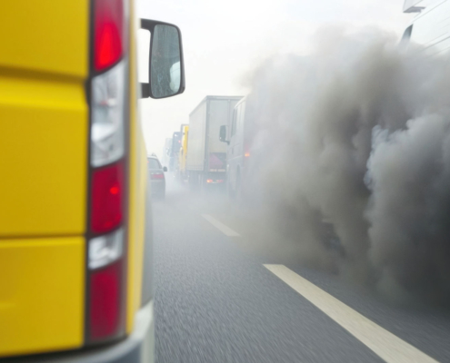 Diesel truck releasing heavy exhaust pollution on freeway linked to South Fresno CEQA violations