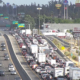 Traffic congestion with diesel trucks and cars on California freeway highlighting pollution impacts in South Fresno