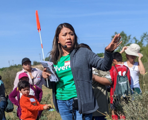Fresno BHC youth leader guiding community members along the San Joaquin River to oppose the CEMEX Quarry Expansion