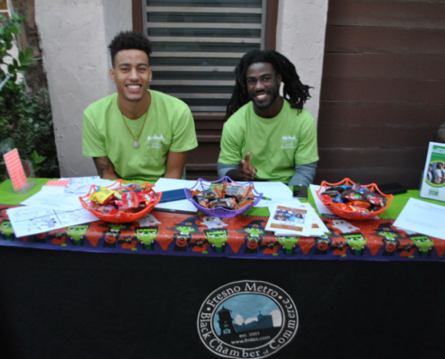 Representatives from Fresno Metro Black Chamber of Commerce hosting a booth at Well-O-Ween Fresno