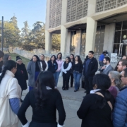 Did Caltrans Shortchange South Fresno? Judge Weighs Highway 99 Expansion Lawsuit A large group of people gathered in a loose circle on a concrete plaza outside a courthouse. They appear to be listening to a speaker, with the architectural details of the building's textured exterior visible in the background.