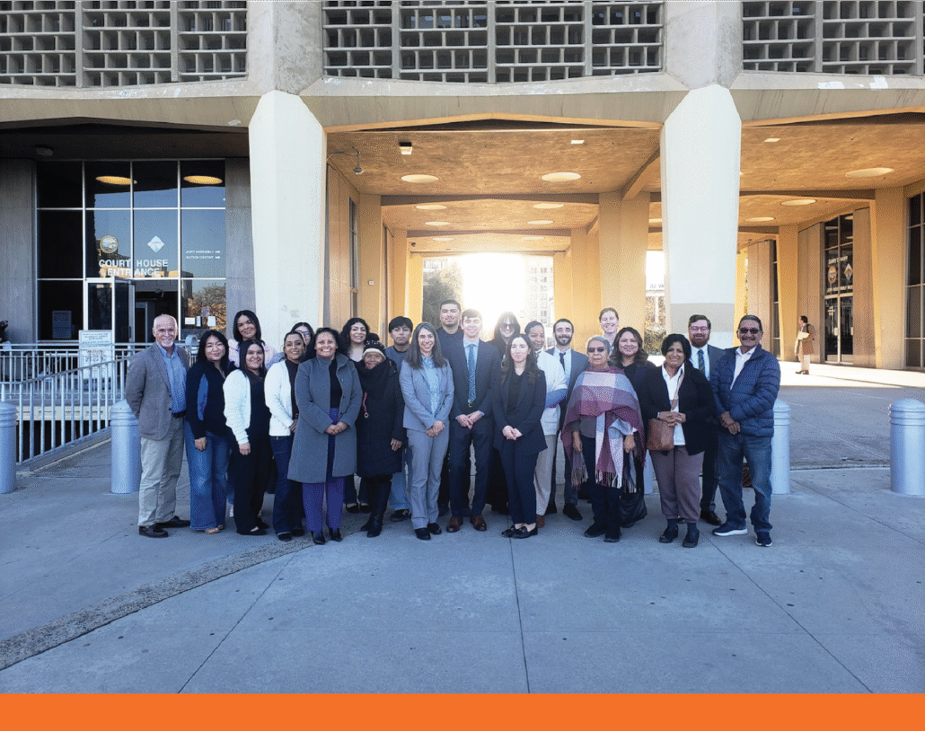Did Caltrans Shortchange South Fresno? Judge Weighs Highway 99 Expansion Lawsuit A wide group portrait of about twenty people of diverse ages and backgrounds standing in front of a modern "Court House Entrance." They are dressed in a mix of professional and business-casual attire. The courthouse features a unique concrete honeycomb-style facade.