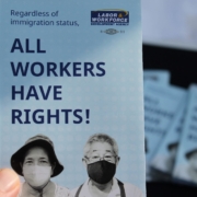 Close-up of a flyer reading “All Workers Have Rights,” emphasizing worker protections regardless of immigration status.