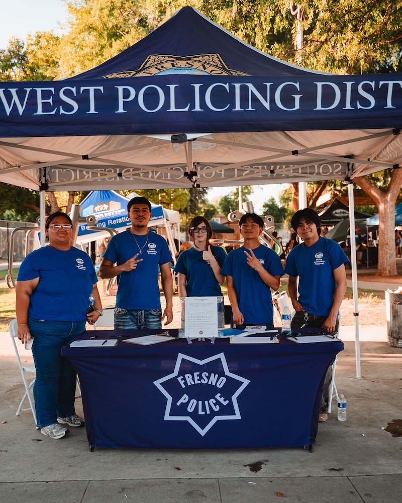 Five young people in blue 