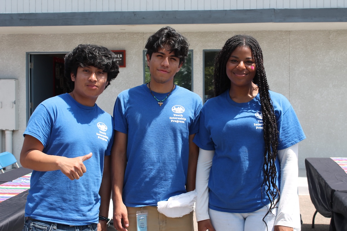 Three young people in blue 